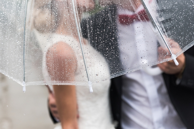 bride and groom under an umbrella