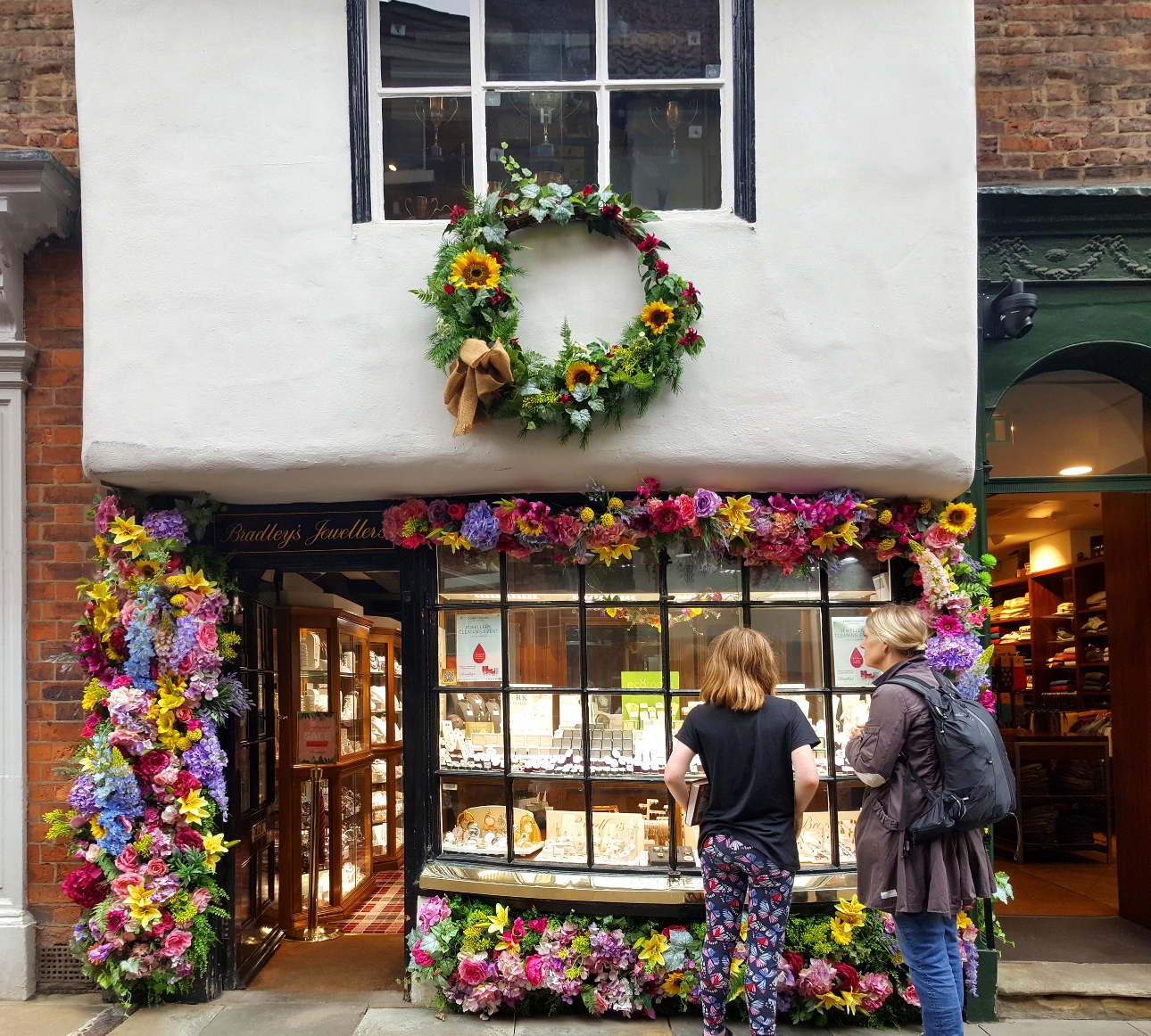 jewellery shop front with wreath hanging over it 