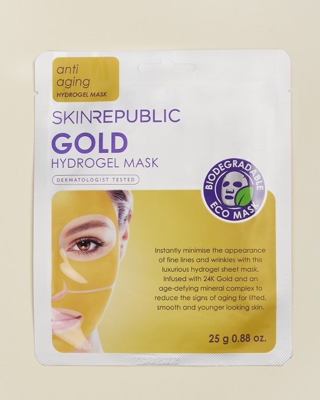 Golden facemask on a beige background