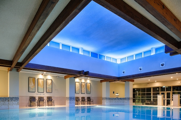 pool area, lit ceiling, chair around edge