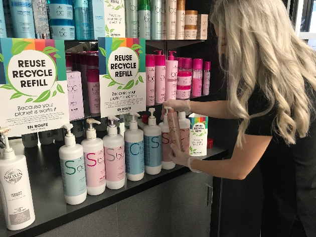 woman in salon moving products on shelf