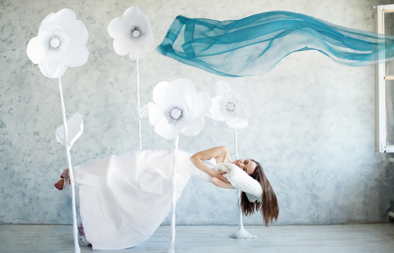 bride floating in the air with head on pillow trying to sleep