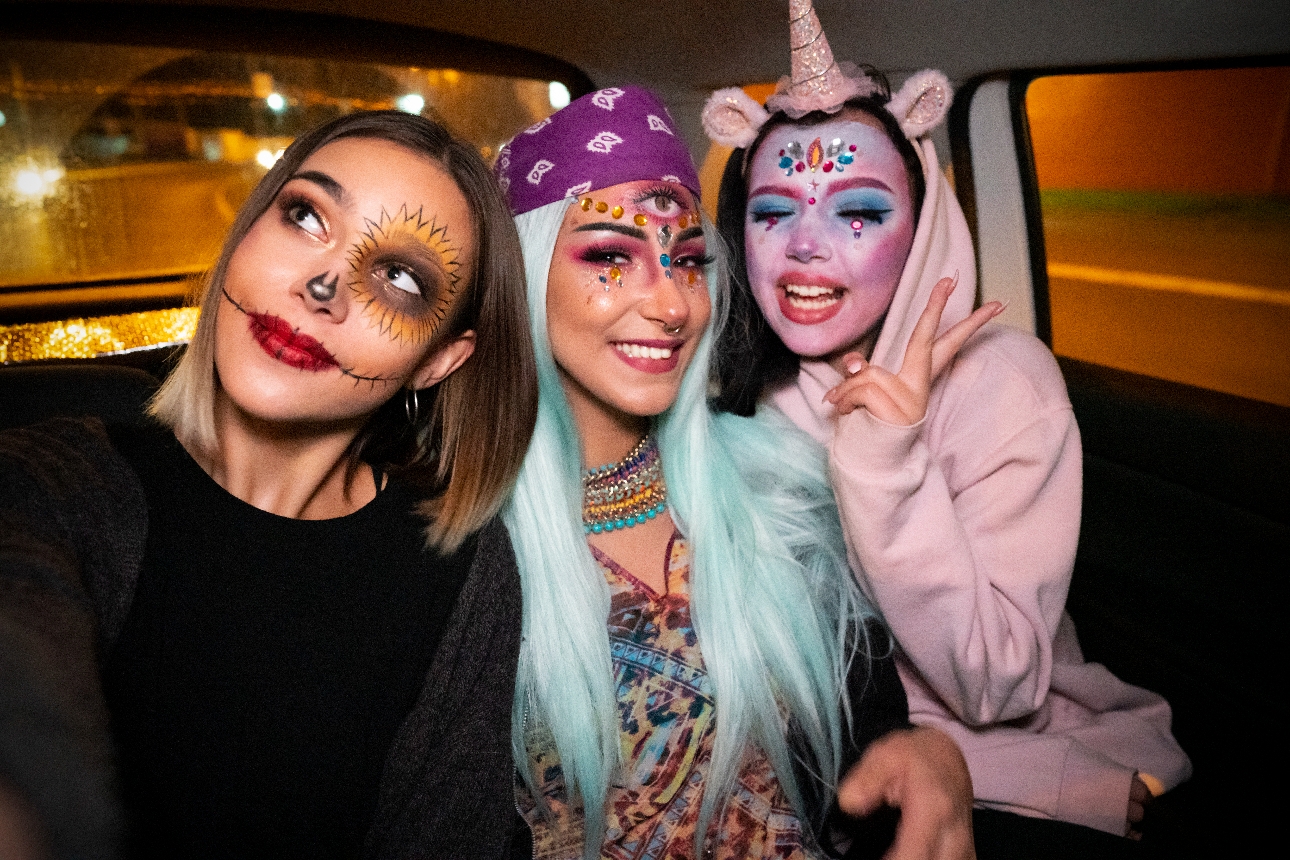 three friends in cab dressed up for halloween