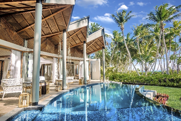 A swimming pool that connects to three bedrooms