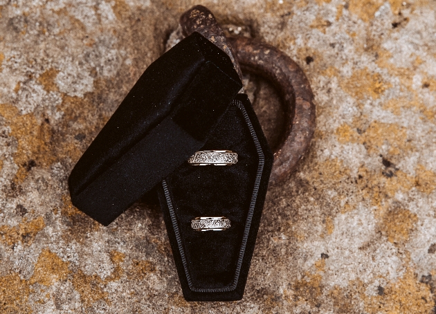 coffin-shaped wedding ring box containing two wedding rings