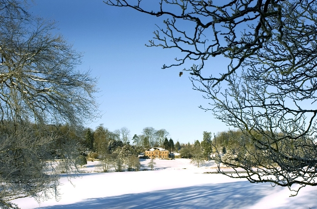 The Coniston Hotel seen from a distance across a snowy landscape