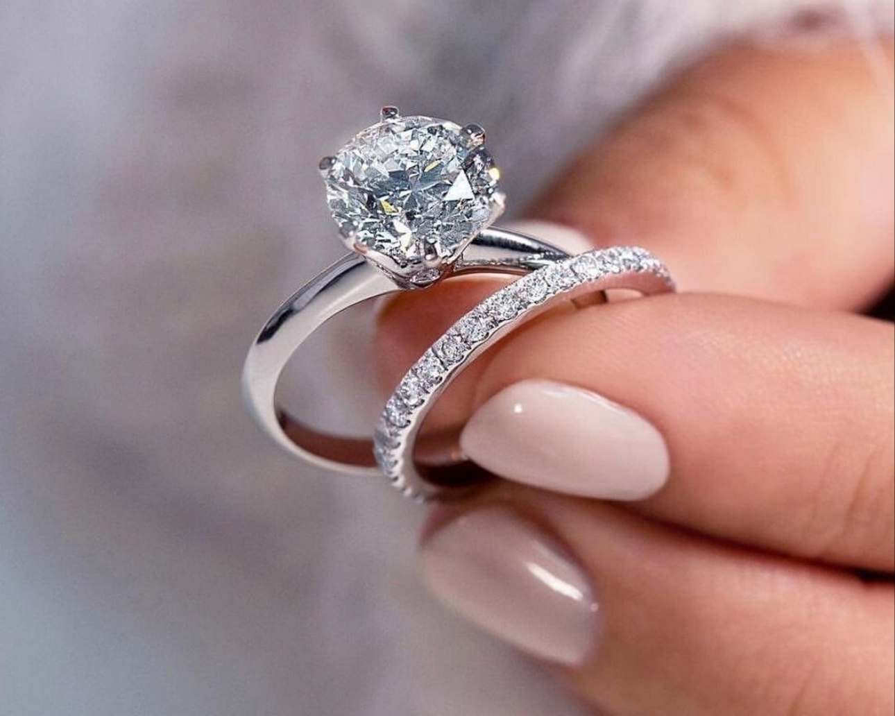 engagement and wedding band with diamond in brides hand
