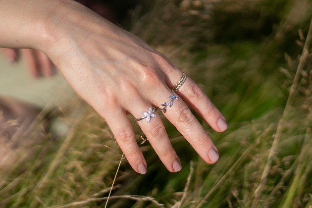 Hand wearing rings from the new Jeweller's Loupe Collection, Serene