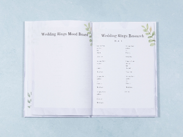 inside wedding planner two white pages with green leaf design