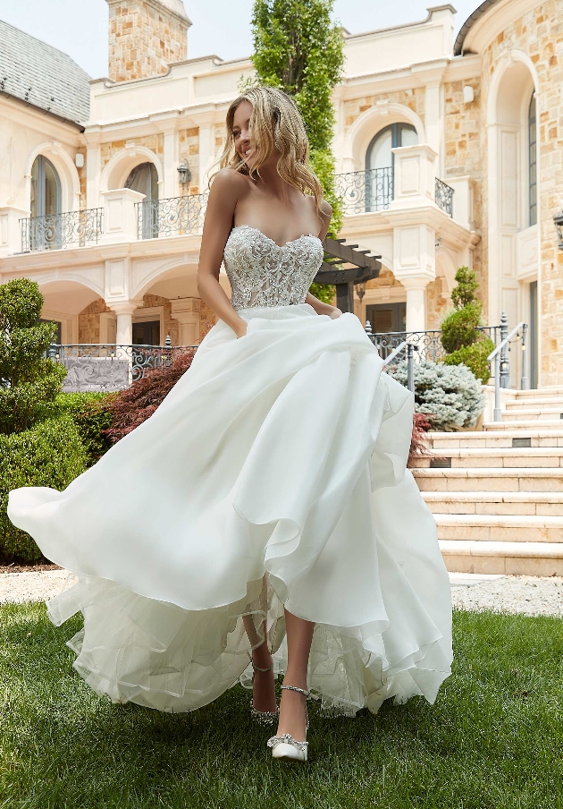 model in strapless lace corset top with plain full skirt