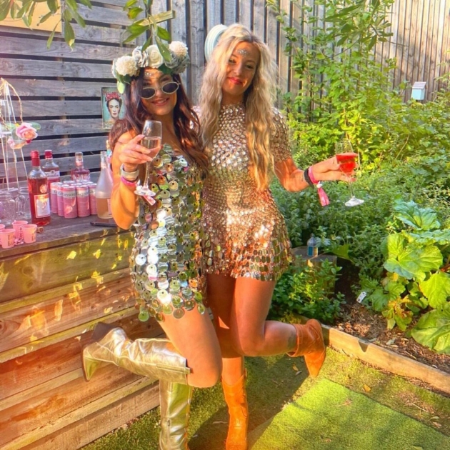 two hens with drinks wearing gold outfits