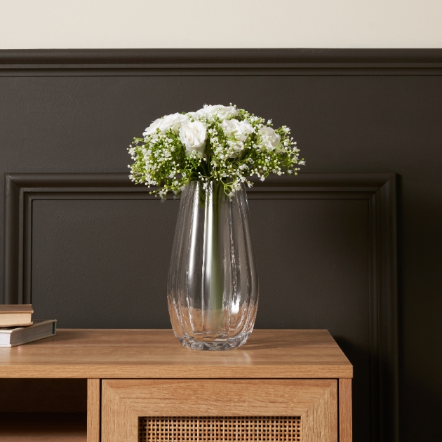 clear vase with white flowers in