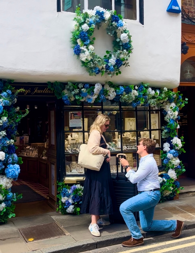 Man proposing to woman in front of Bradley's Jewellers of York