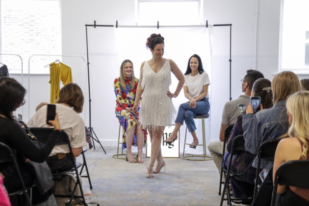 woman on runway wearing white tassled dress