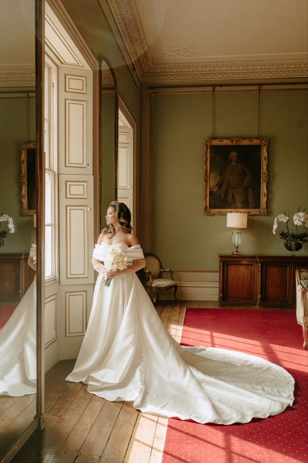 bride standing at the window at Rise Hall 