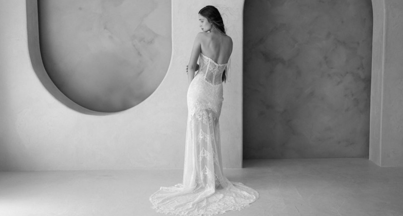 black and white image of model in a wedding dress in a back shot pose