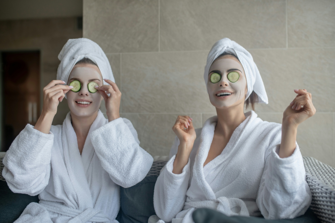 two women in bath robes sitting in spa